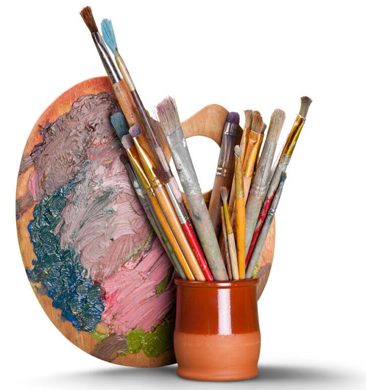 Wooden art palette with blobs of paint and a brushes on white backgroiund